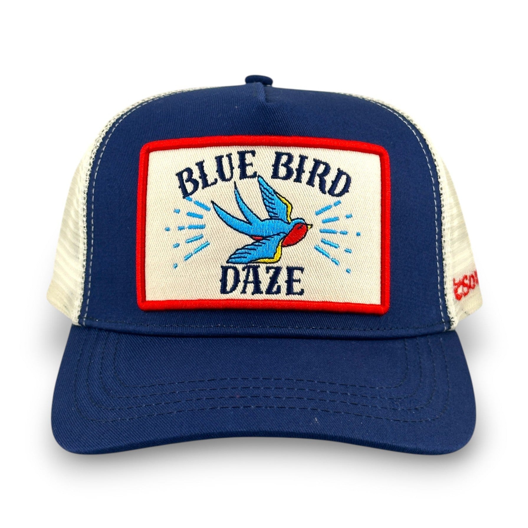 Front view of navy trucker hat featuring blue bird embroidery and beige patch
