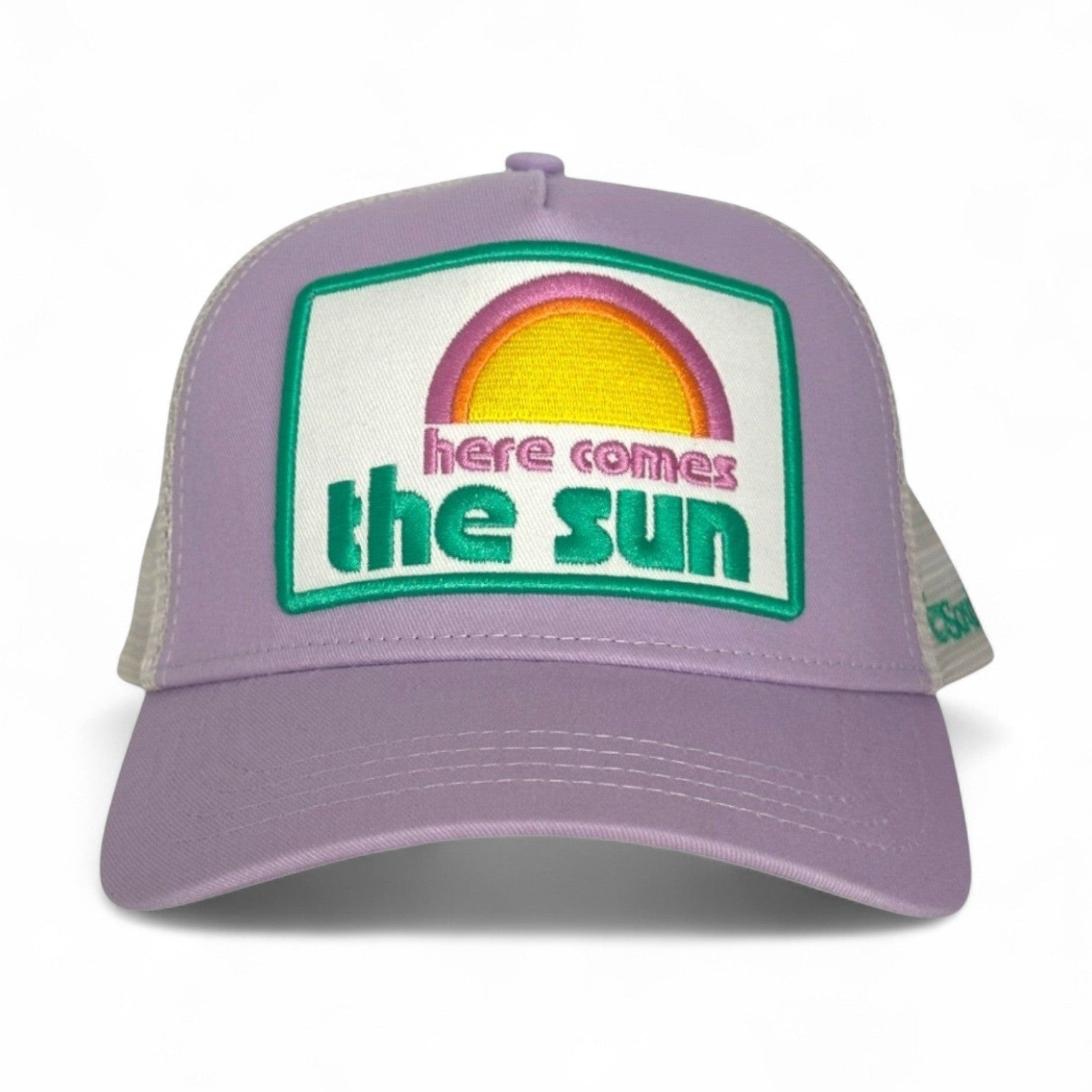 Lilac cotton trucker hat with adjustable snap back and embroidered sunburst 'Here Comes the Sun' patch