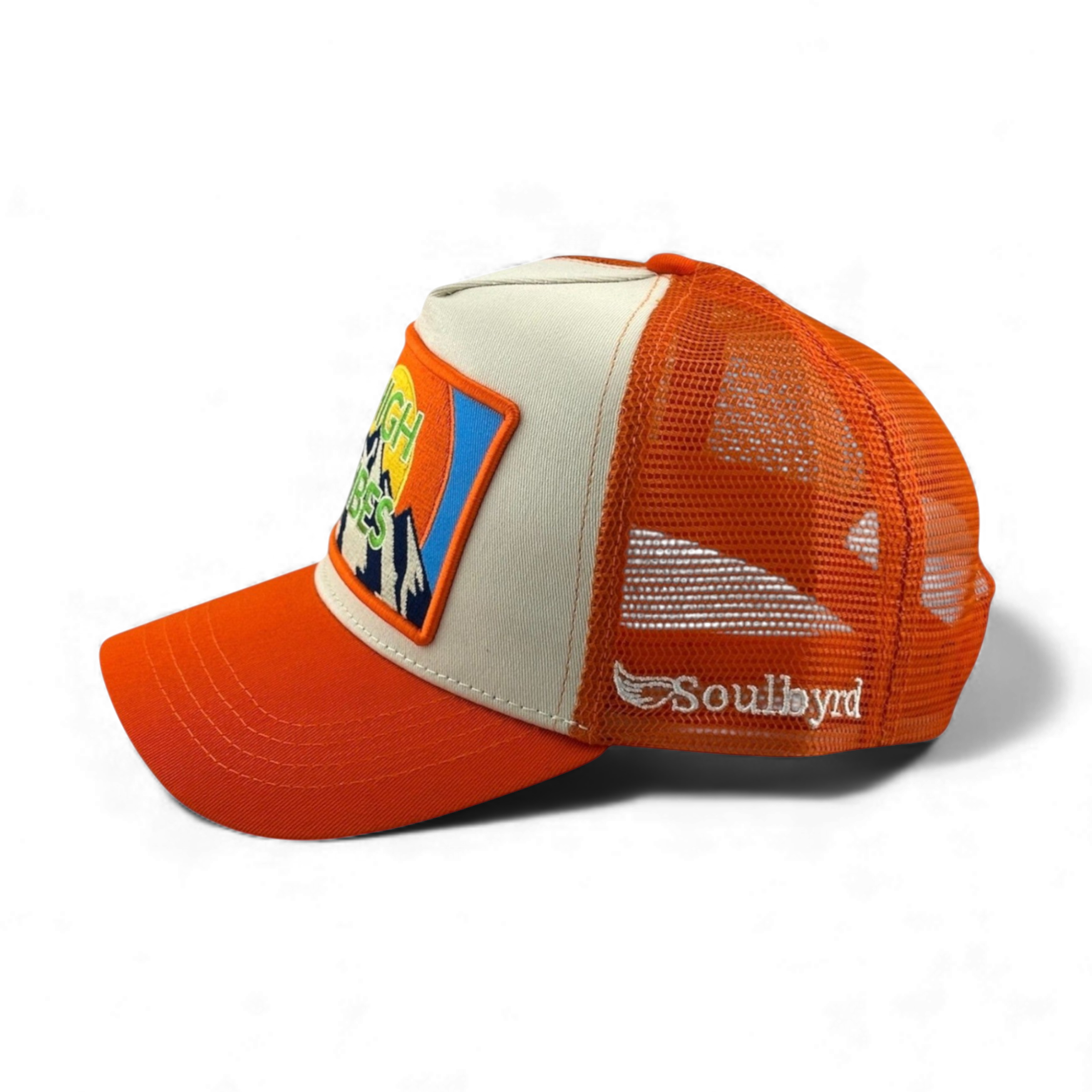 Side view of orange mesh Soulbyrd trucker hat with wing logo