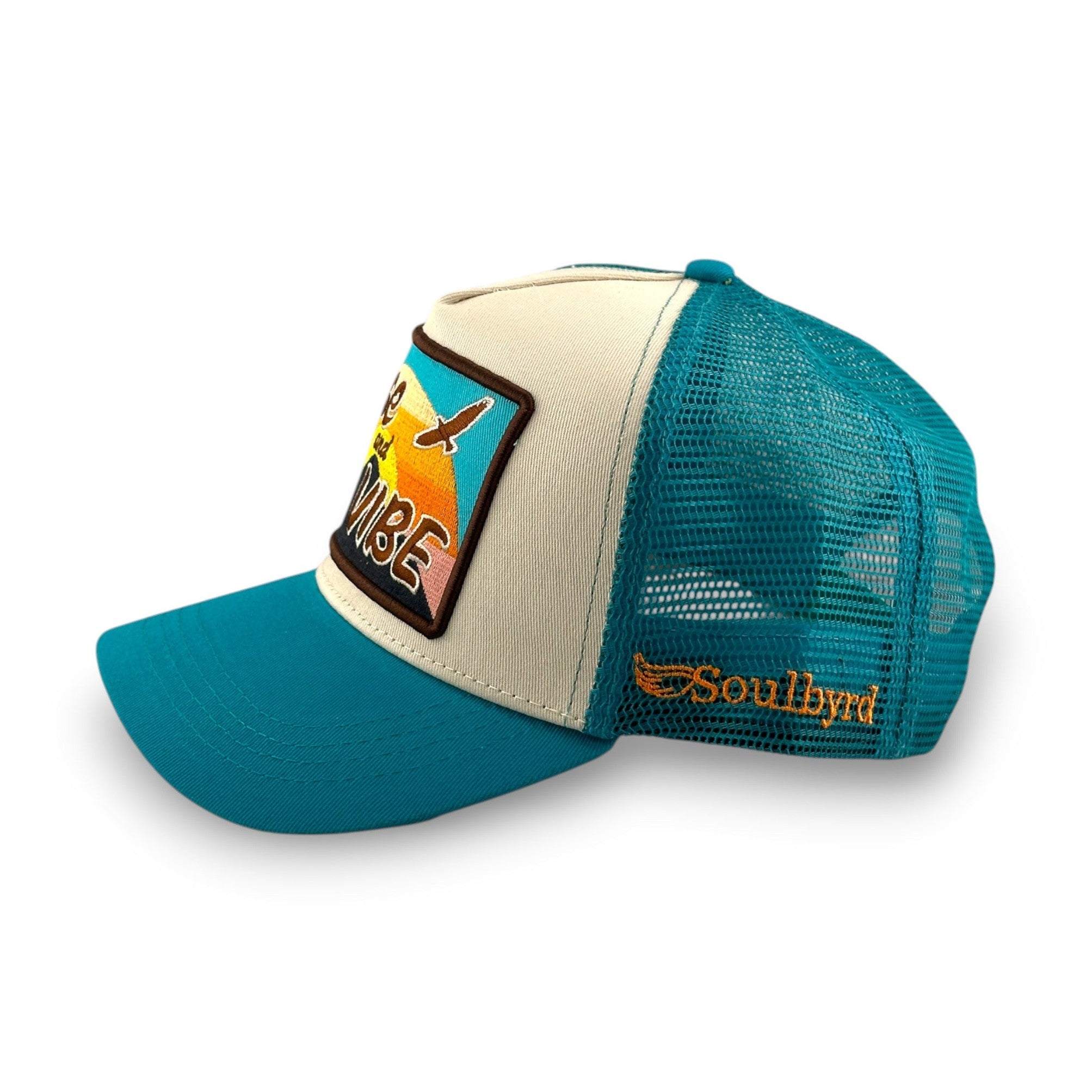 Soulbyrd turquoise mesh back trucker hat showing adjustable snap closure and side winged logo