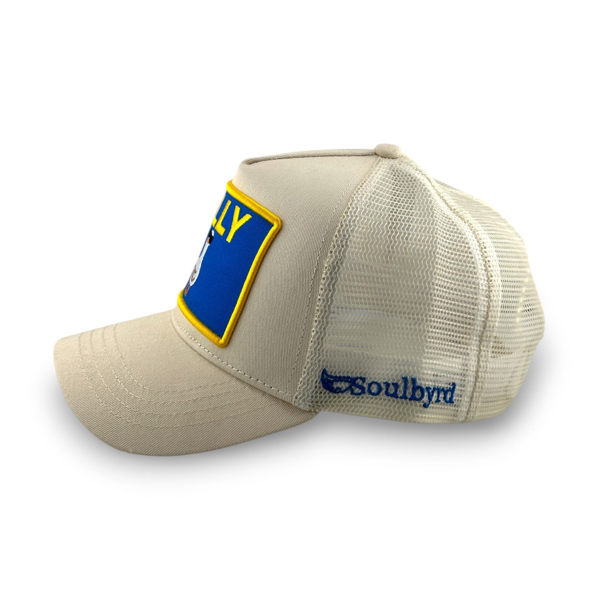Side view of cream cotton twill trucker hat showing Soulbyrd mesh back logo