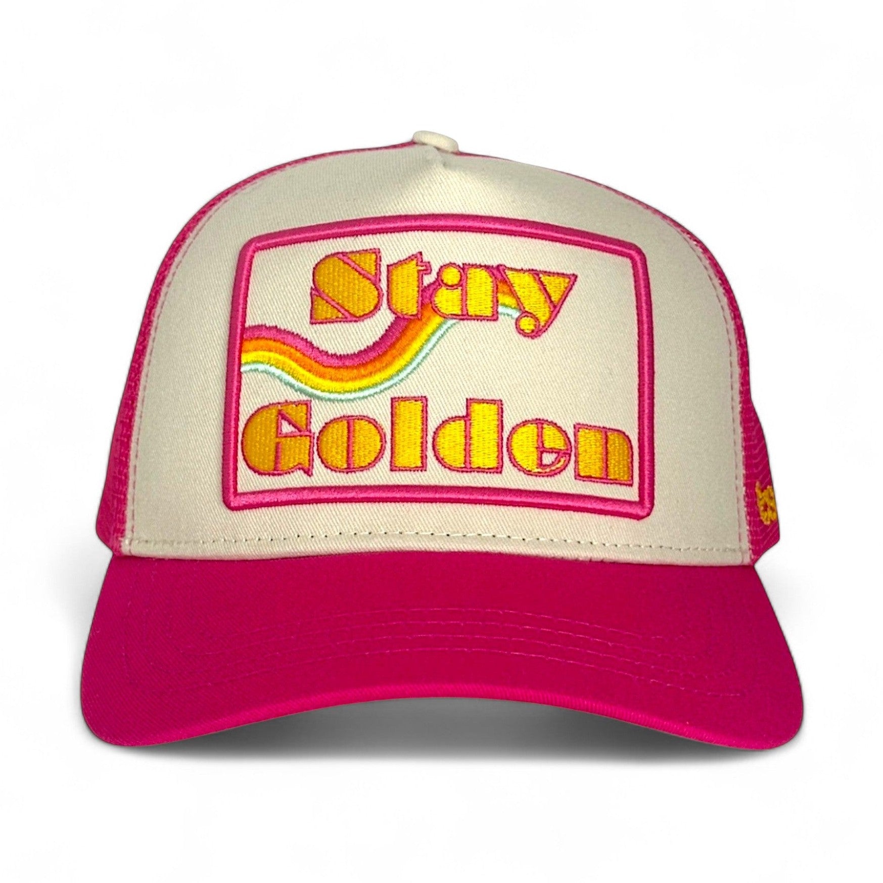 Pink and off-white trucker hat with embroidered Stay Golden patch and rainbow wave design