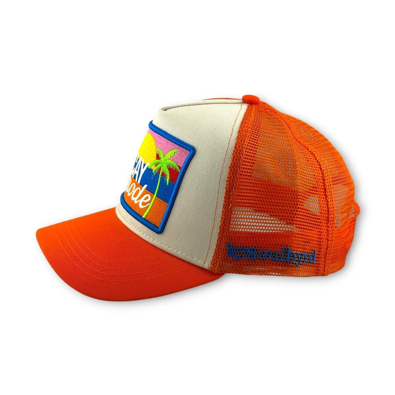 Side view of Soulbyrd orange mesh trucker hat with blue brand embroidery