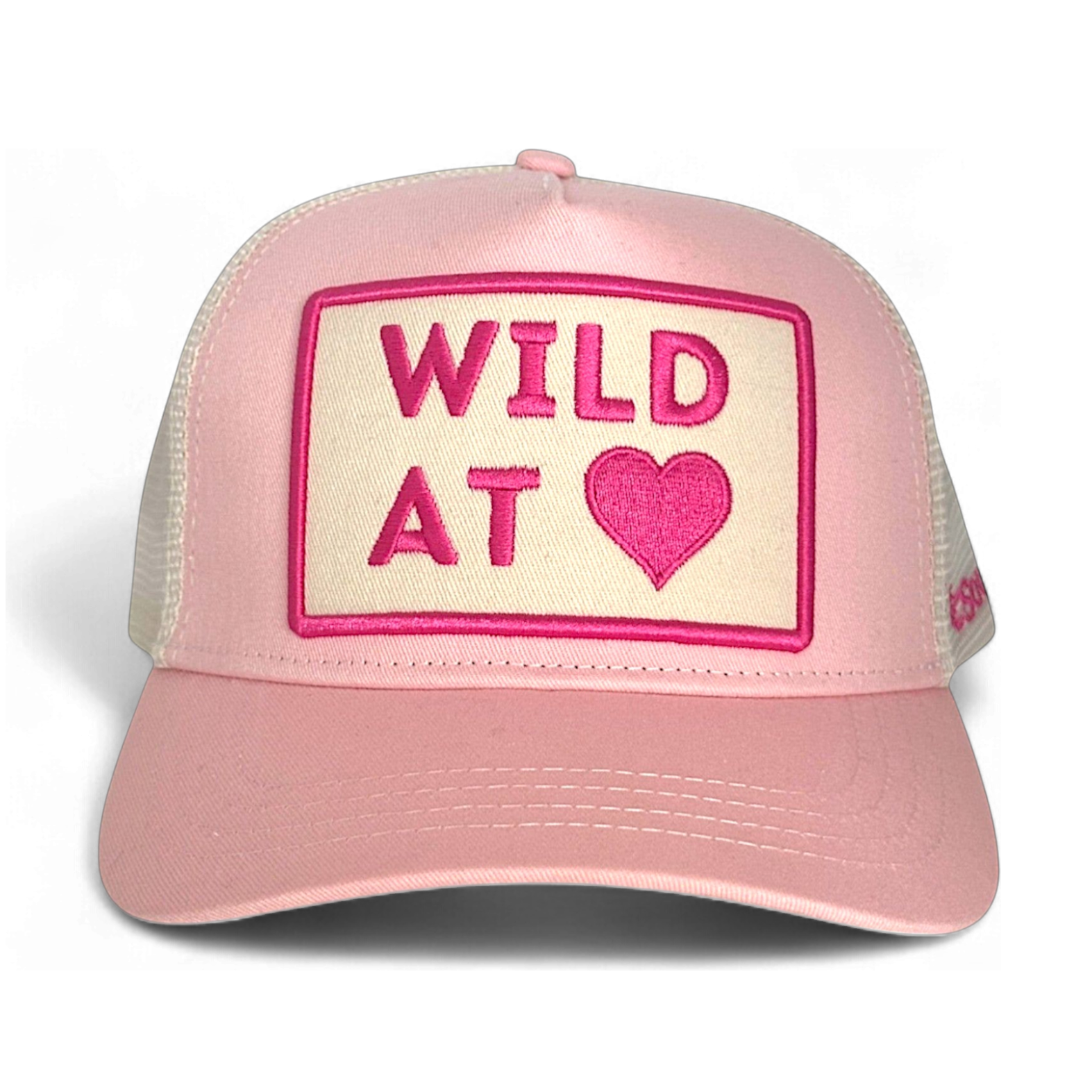 Front view of pink cotton twill Wild at Heart trucker hat with embroidered heart patch