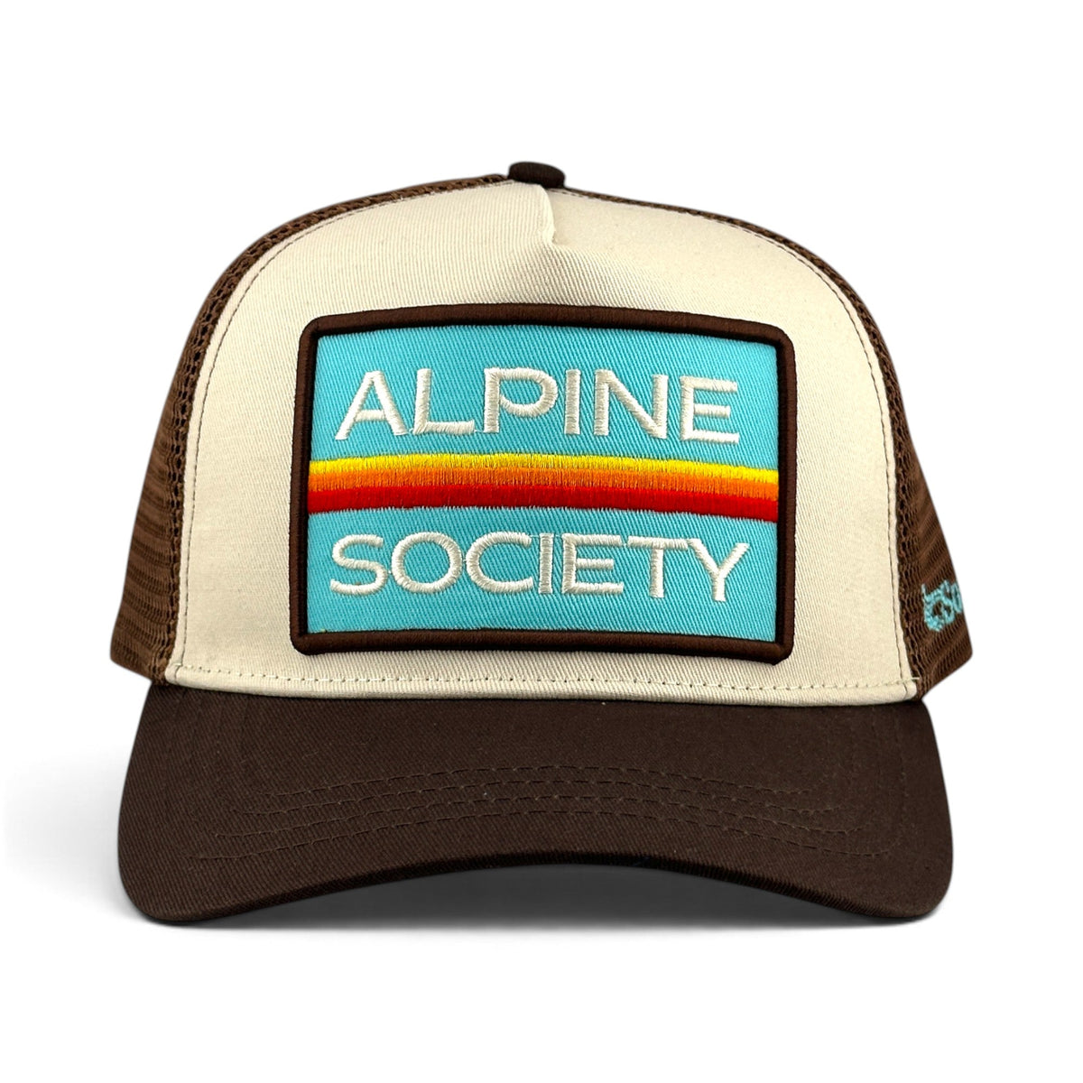 Soulbyrd Wholesale Alpine Society brown and cream trucker hat with a blue patch and adjustable snapback closure