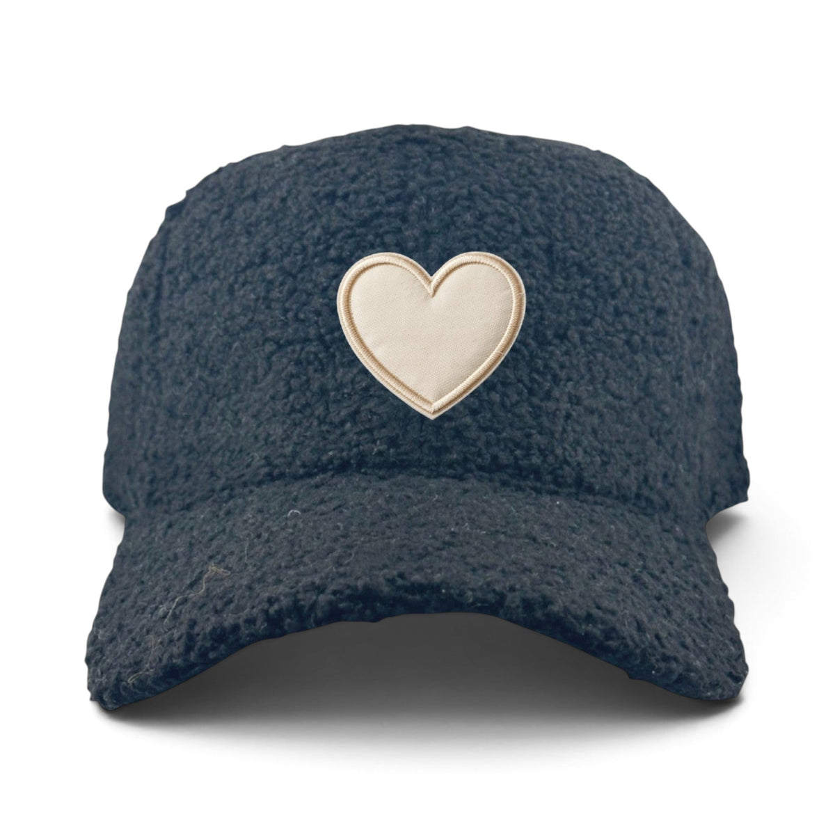 Soulbyrd Wholesale black faux sherpa trucker hat with a cream embroidered heart patch on the front