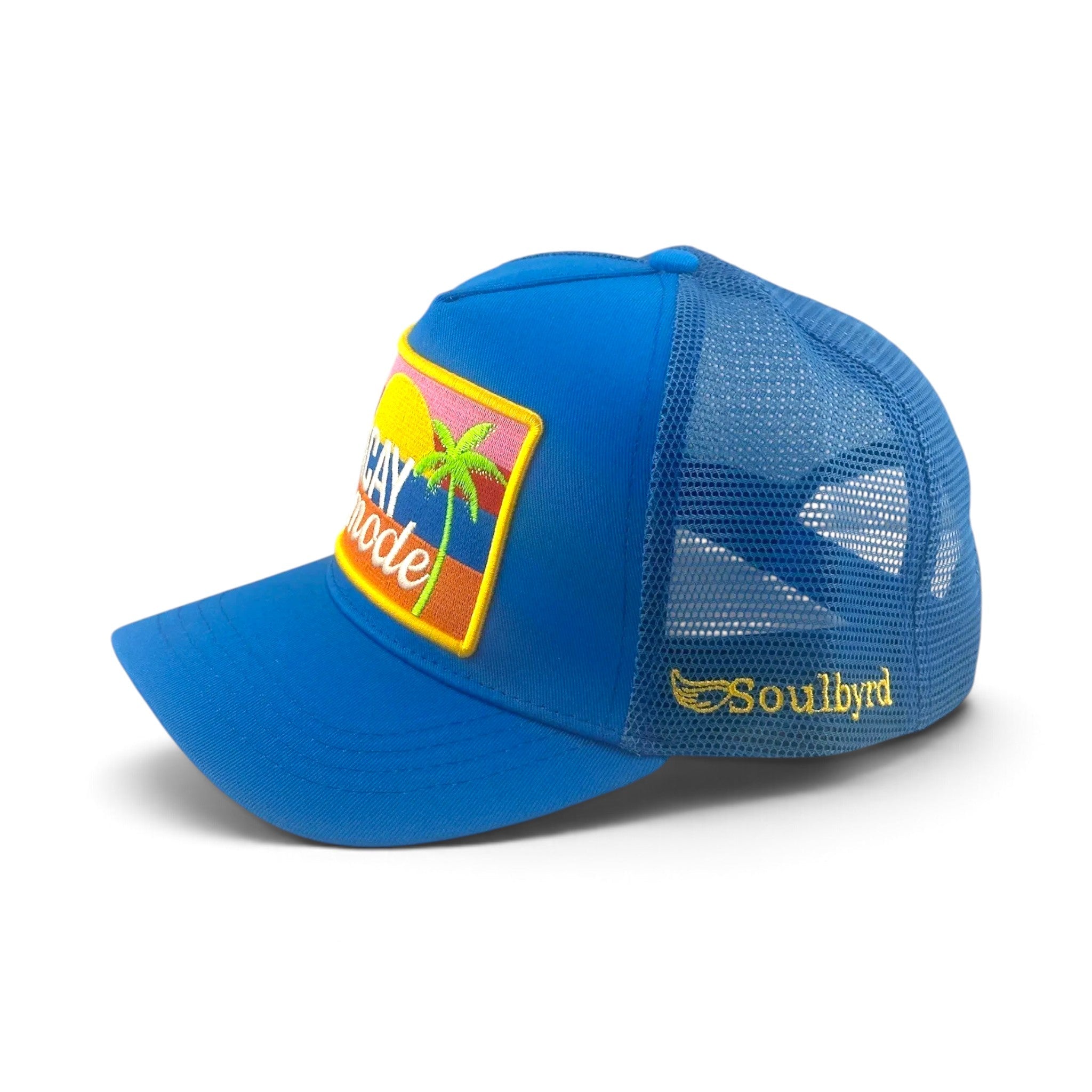 Soulbyrd Wholesale blue trucker hat with Vacay Mode patch, cotton twill crown, and breathable nylon mesh back.