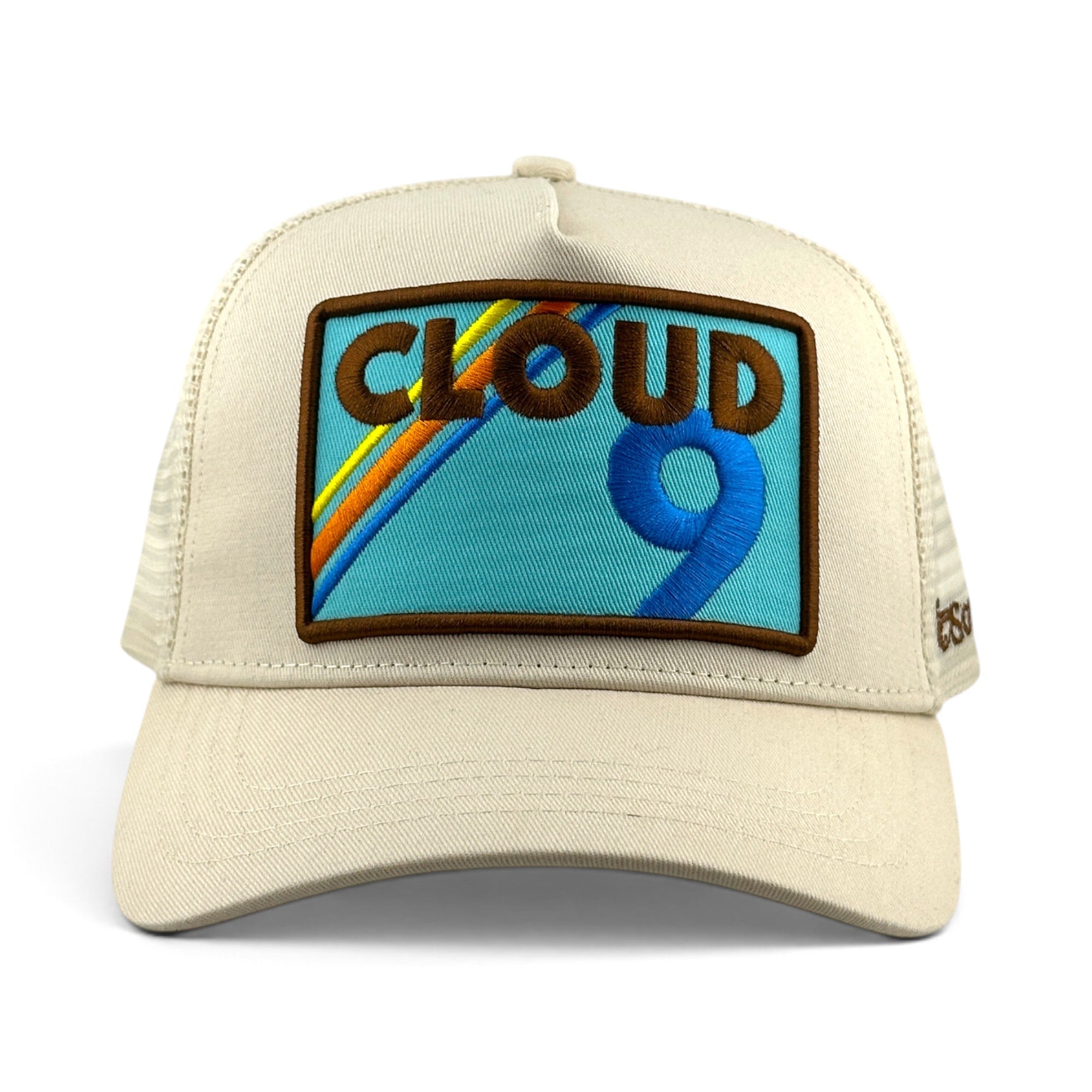 Soulbyrd Wholesale cream 5-panel trucker hat with a Cloud 9 embroidered patch featuring a rainbow and blue number 9.