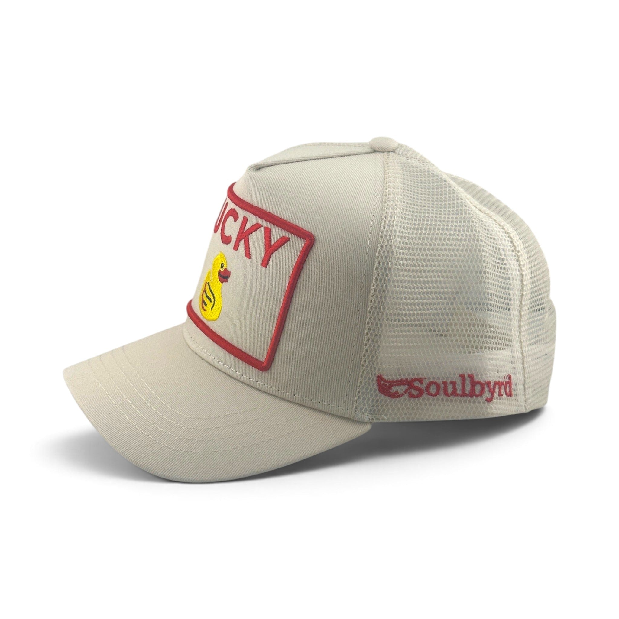 Soulbyrd Wholesale cream trucker hat with Lucky Duck patch, cotton twill front, and breathable nylon mesh back.