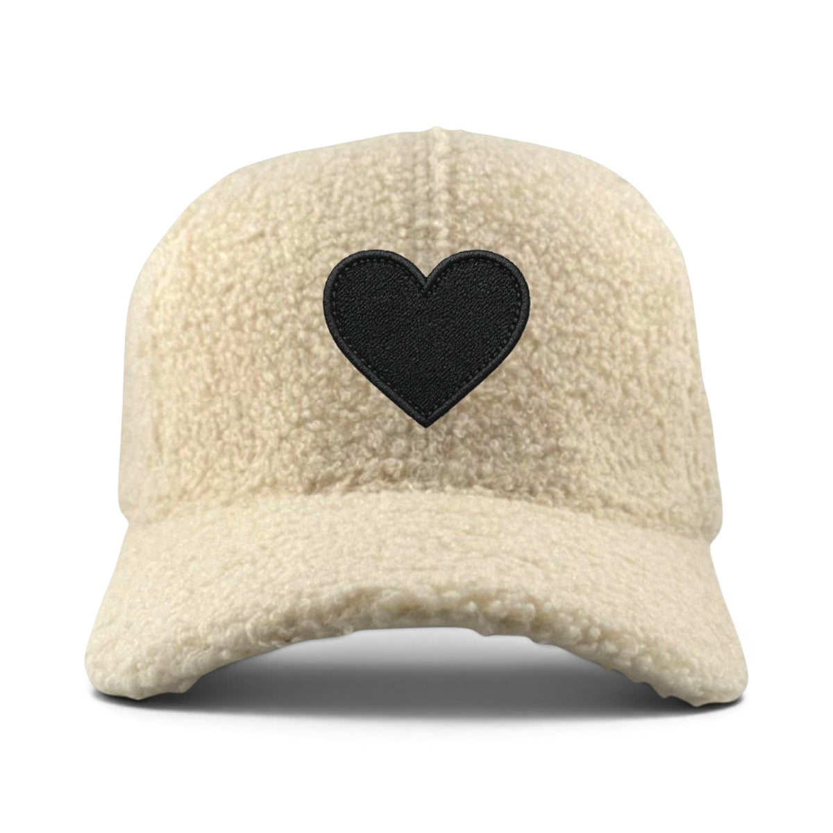 Soulbyrd Wholesale cream faux sherpa trucker hat with a black embroidered heart patch on the front