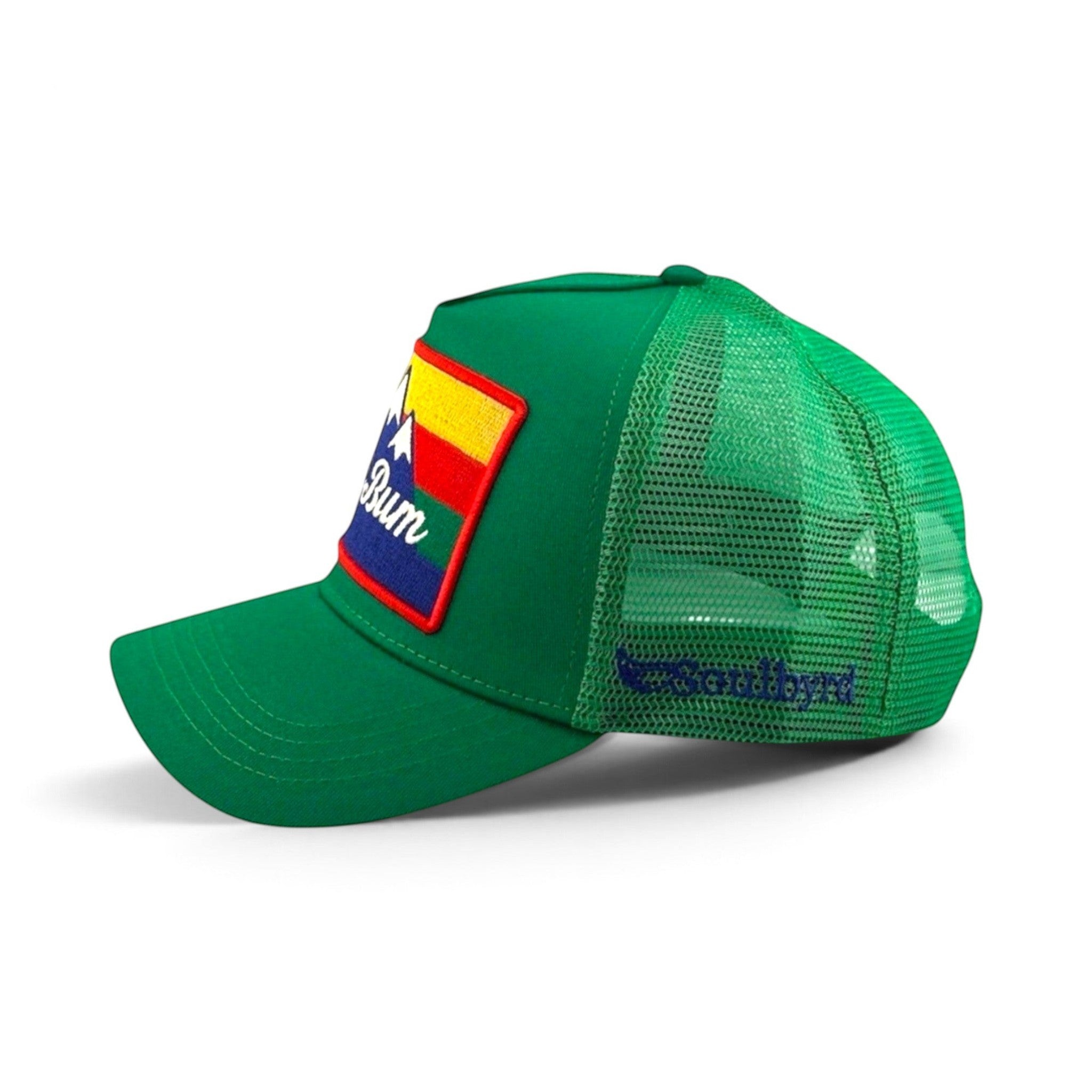 Soulbyrd Wholesale green 5-panel trucker hat with cotton twill front, nylon mesh back, and Ski Bum mountain patch.